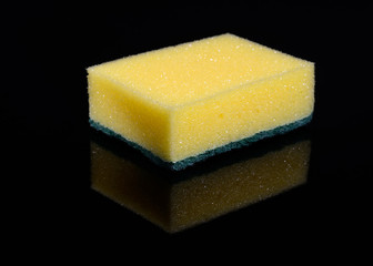 Kitchen cleaning sponge on mirrored black background