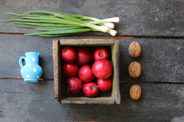 Apples in a box and Fresh Spring Onions on the farmers market.