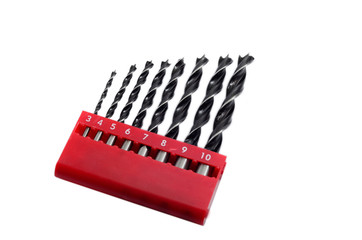 Set drill bits in box in white isolated background.