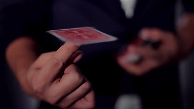 Card trick. The magician's hands.