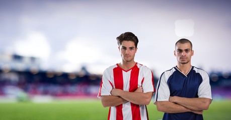 soccer players with his hands folded, blurred field background