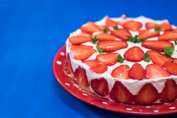 Strawberry cake with sour cream on a blue background