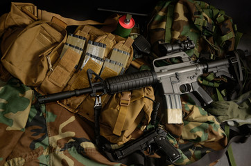 Assault rifle 5.56mm m16 Colt carbine with tactical chest rigs. Military Equipment.
