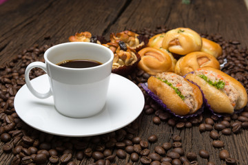Coffee cup with bread sausage and coffee beans