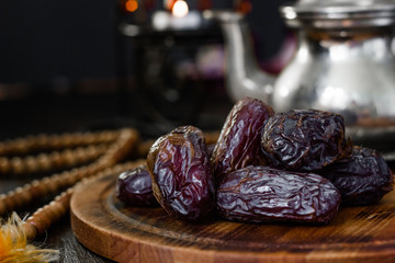 Dates for iftar on wooden board for ramadan month.