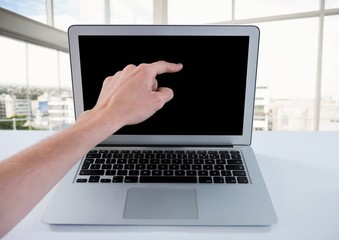 Hand pointing at laptop with windows