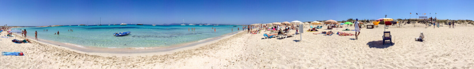 FORMENTERA, SPAIN - JUNE 2015: Tourists enjoy wonderful island beach, panoramic view. Formentera is...