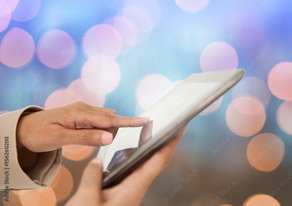 Poster hand touching tablet with sparkling light bokeh background