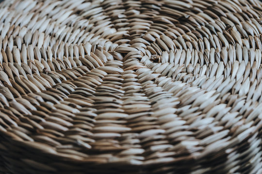 Handmade authentic straw round basket macro closeup geometric texture.