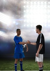 soccer player giving hands in lights field