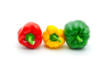 Green, yellow and red fresh bell pepper or capsicum isolated on white background.