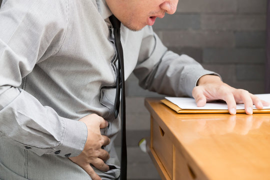 Asian Business Man With Stomachache In Office