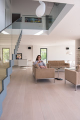 young woman in a bathrobe enjoying morning coffee