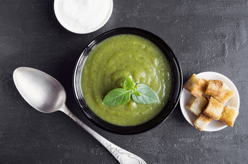 vegetarian cream soup of green vegetables. on a black background