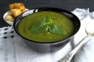 vegetarian cream soup of green vegetables. on a black background