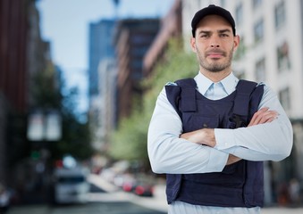 Security guard with arms folded against blurry street