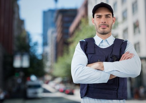 Security Guard With Arms Folded Against Blurry Street