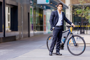 Successful businessman riding bicycle