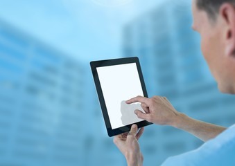 Doctor holding tablet with tall blue buildings