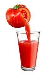 Fresh juice pours from tomato vegetable into the glass isolated on white background.