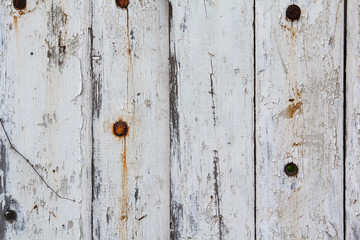Old fence painted in white paint. Backgrounds and textures