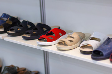 Variety of sandals on the shop counter. Shoes