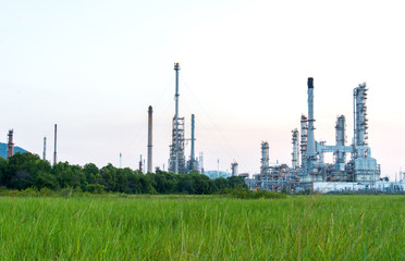 Oil refinery plant at sunrise with sky background