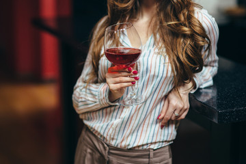 Portrait of a beautiful woman with a glass of wine in her hand