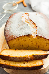 Cinnamon gluten free loaf cake on wooden board.