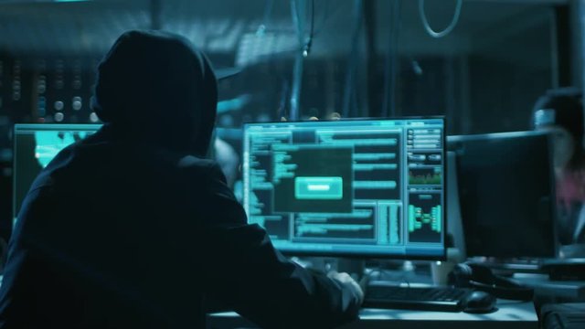 Hooded Teenage Hacker Successfully Attacks Global Infrastructure Servers with Malware. Display Showing Stages of Hacking in Progress: Exploiting Vulnerability, Executing and Granted Access. 