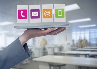 Businesswoman holding tablet with apps icons in workshop factory
