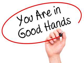 Man Hand writing You Are in Good Hands with black marker on visual screen
