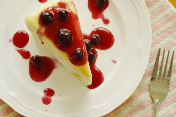 crape cake dressing blueberry sauce on plate