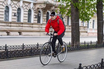Fototapeta premium young man riding on fiexedgear bicycle in the streets of old european city