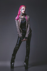 Female model with body painting futuristic on the face and clothes of punk style