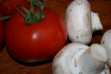 tomato's and mushrooms on wood background