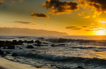 Sunset at Hawaii's north shore with waves