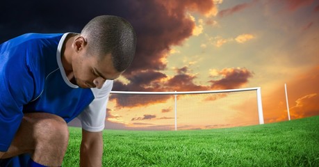 soccer player tying the shoes in the field