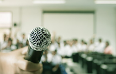 blurred of teacher teaching and speech, talking with microphone in classroom, gray scale tone