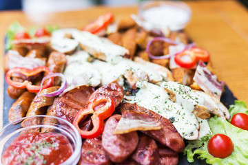 Mixed meat grill with grilled vegetables and sauce