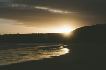 sunset over beach and mountains australia