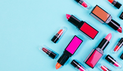 Various of vivid color lipstick make up on pastel blue effect vintage background. Lipstick background with copyspace for text.