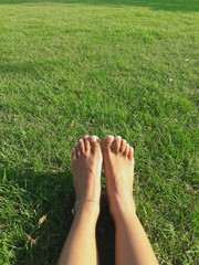 Chill and relaxing on green grass in the park in summer