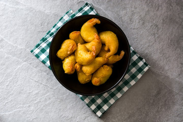 Deep fried shrimps in a bowl on gray stone
