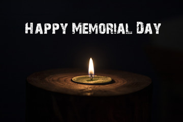 Memorial day, inscription on black background and candle