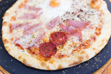 Traditional Italian pizza four seasons with four different flavors.  