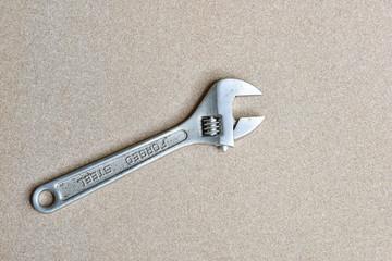 A forge adjustable wrench spanner tools lying on wood background