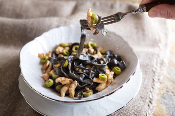 Black ink pasta with chicken and green olives