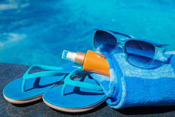 Sunglasses sunscreen cream blue slippers towel