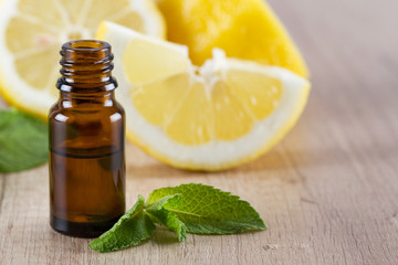 Lemon essential oil and fresh lemon